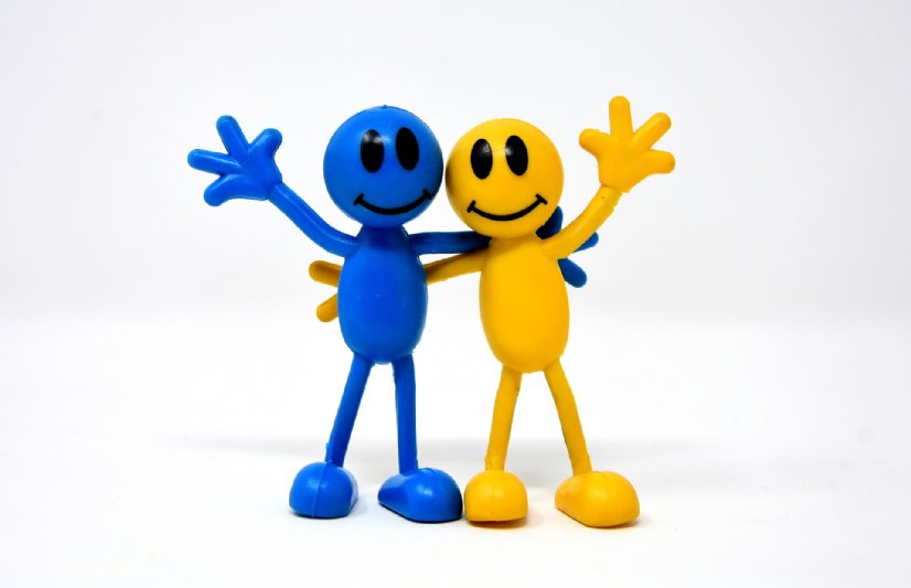 A befriending match is made - friends standing together waving and smiling